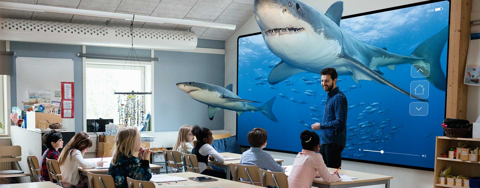 An image of a classroom with shark models hanging from the ceiling and an aquarium background. The shark models add an engaging and interactive element to the learning environment, creating a visually stimulating atmosphere for educational purposes.