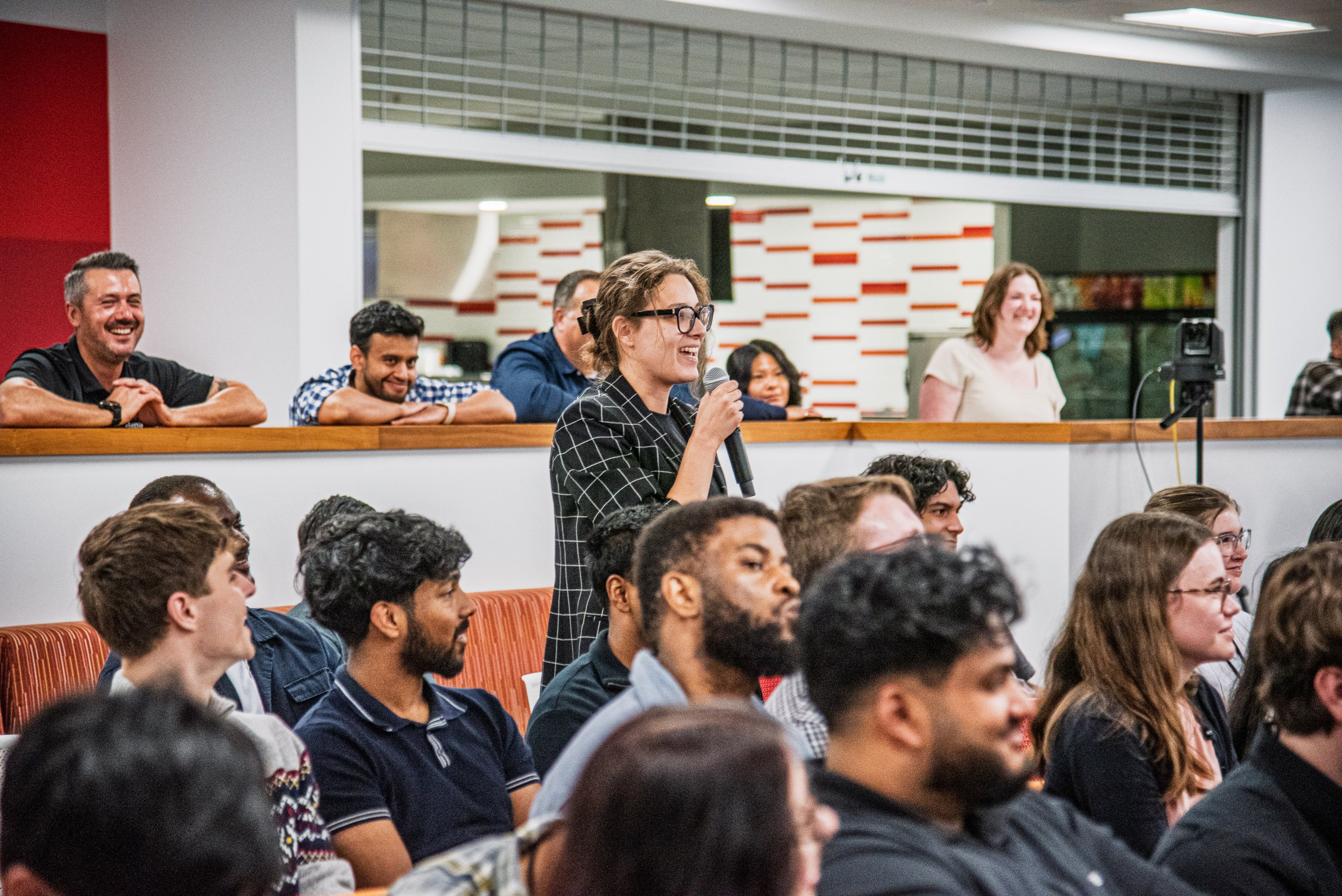 group of people posing in front of wall