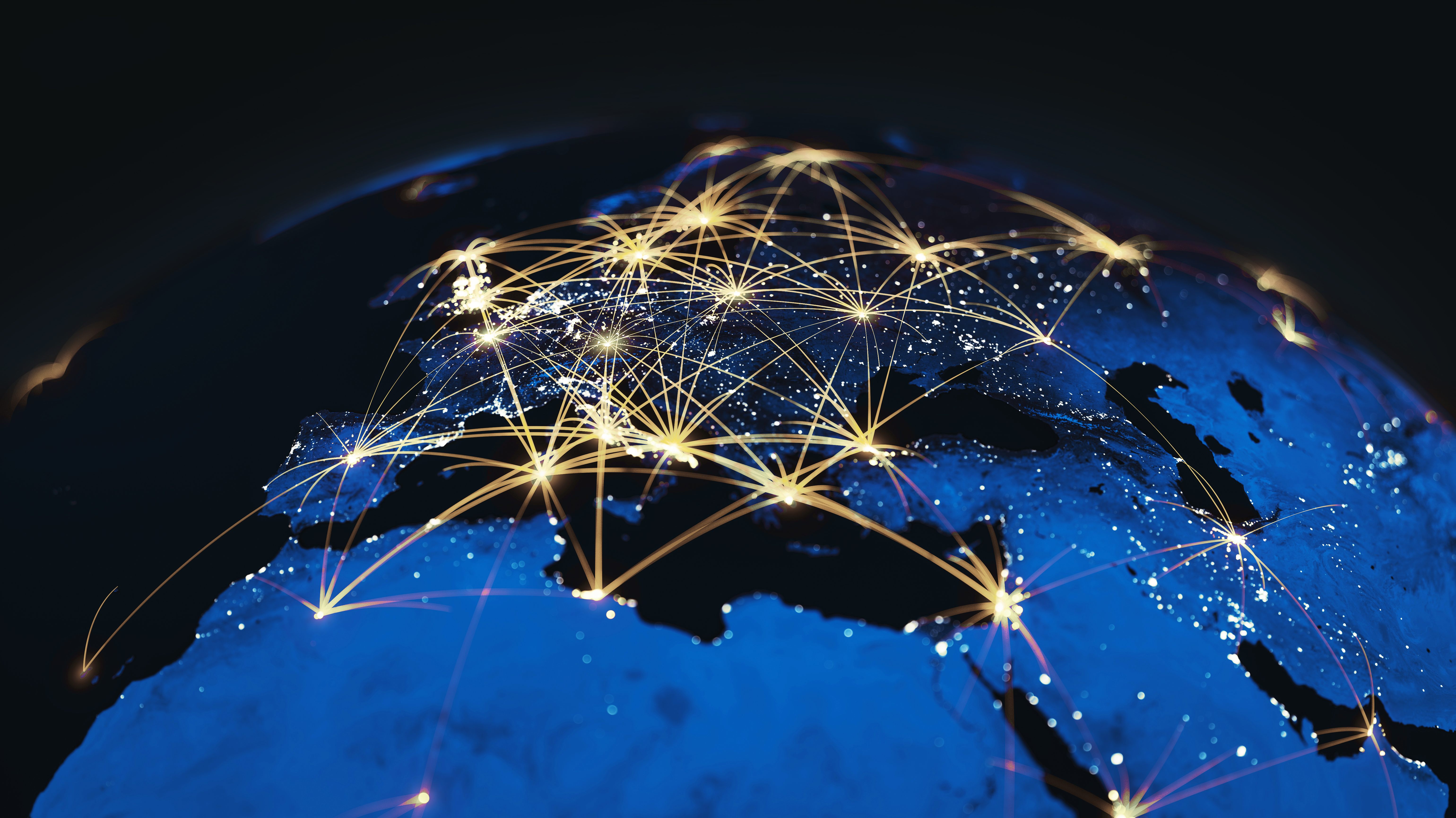 Night view of Earth with glowing network lines linking cities across Europe, Africa, and the Middle East
