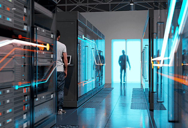 a man standing in a data center with another man standing outside of the door of the data center